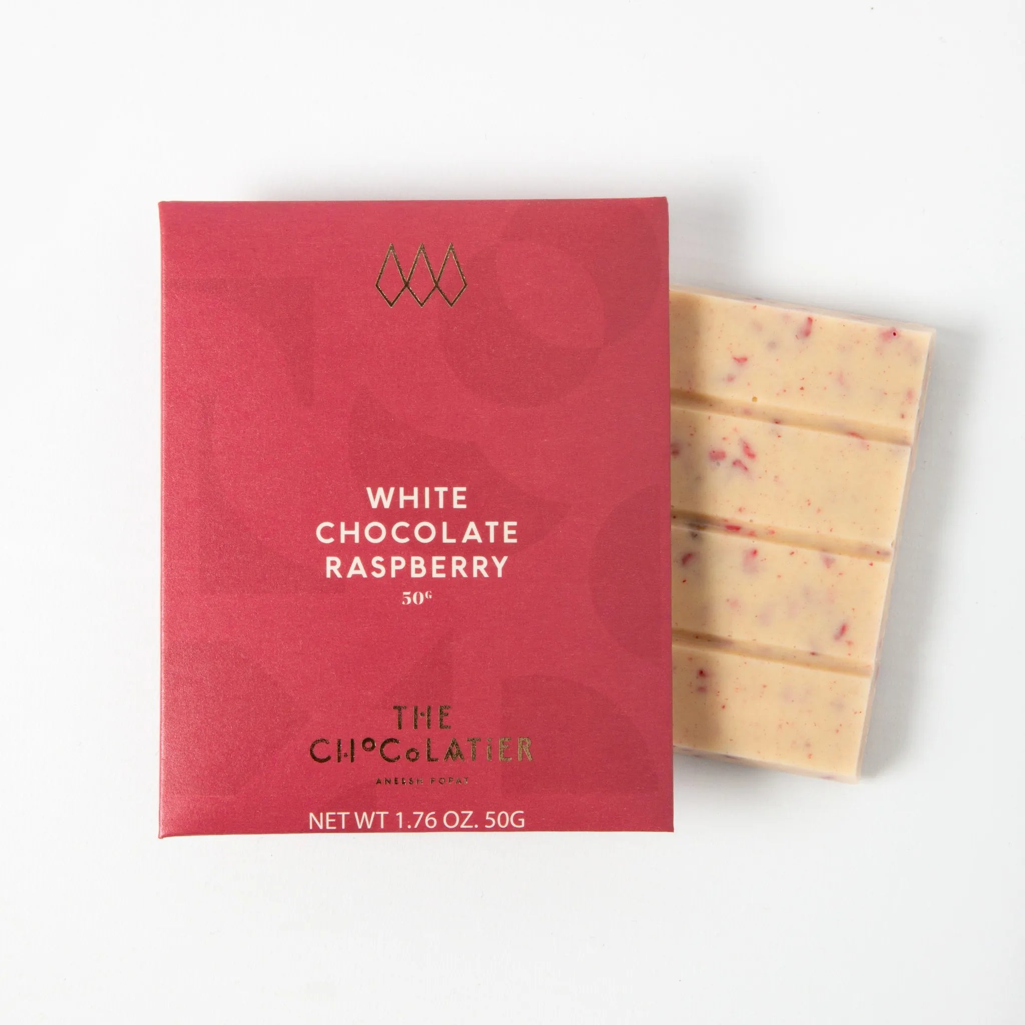 White chocolate raspberry bar by The Chocolatier – creamy white chocolate blended with raspberry pieces, available from Tea Lab