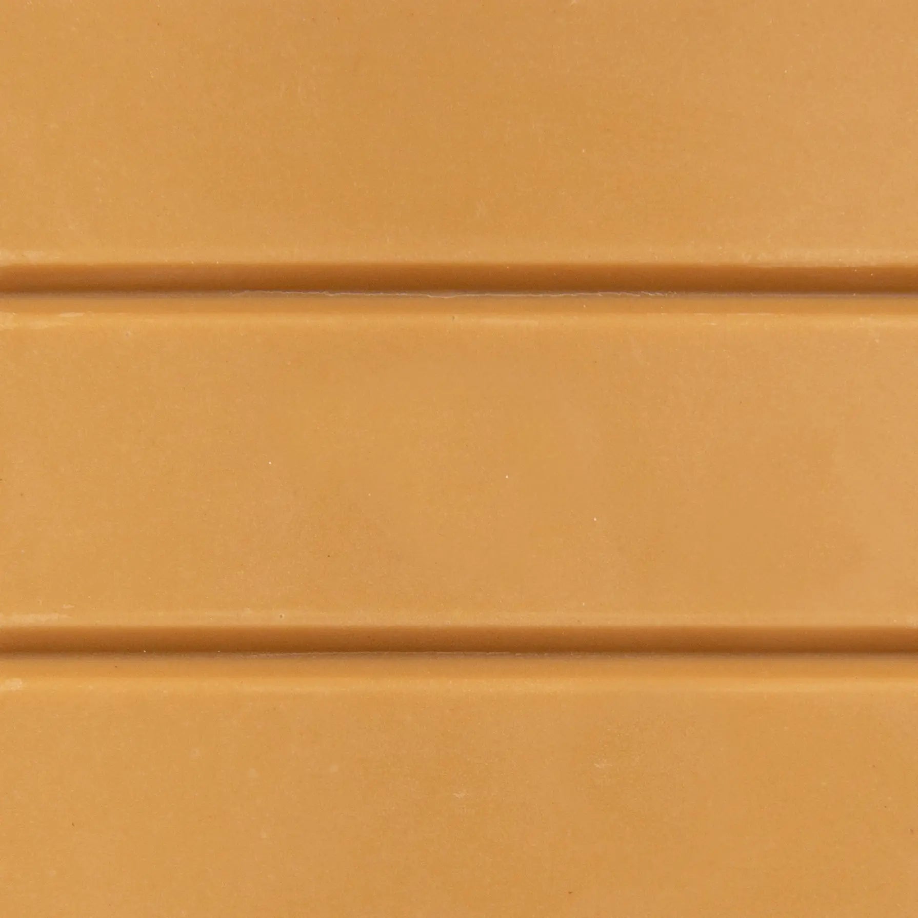Close-up of The Chocolatier’s salted caramel chocolate bar showing its smooth, creamy texture — artisan chocolate available at Tea Lab