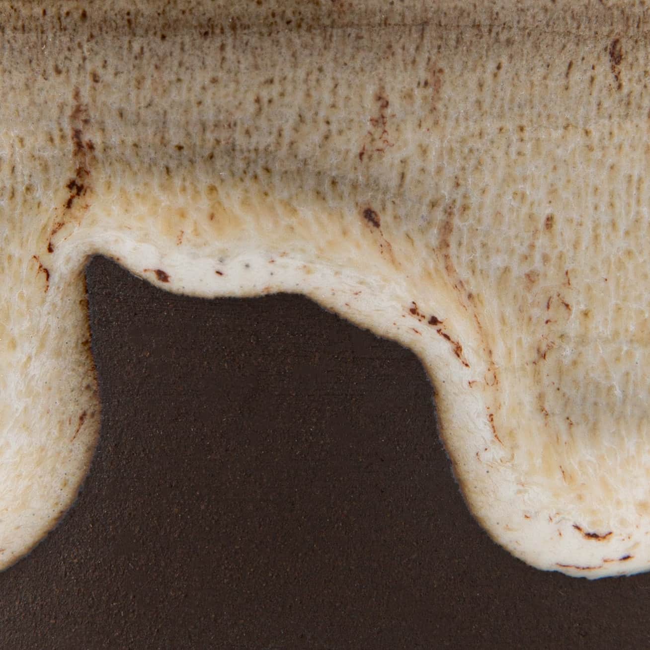 Close-up of a ceramic glaze with brown and beige colors