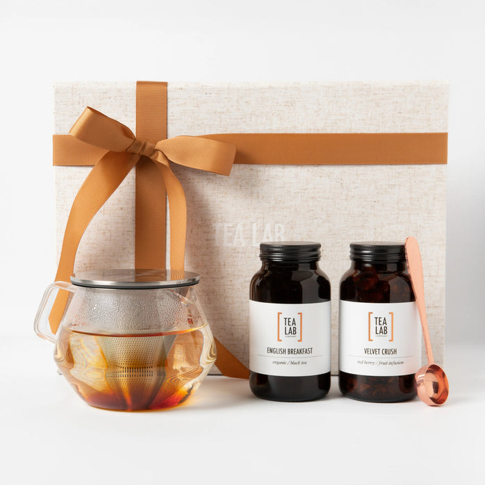 loose leaf tea gift set with glass kinto tea pot and 2 jars of tea, with a cooper tea scoop, presented in a linen box with ribbon